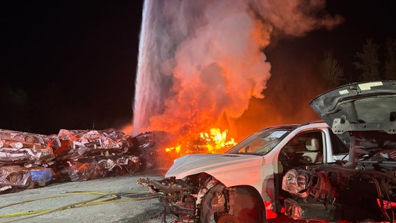 Fire at auto wrecking yard in Graham, WA, sparks explosions