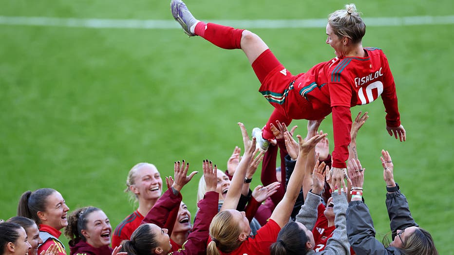 CARDIFF, WALES - OCTOBER 25: Jess Fishlock of Wales is thrown in the air by her teammates as they celebrate her final international game before retirement after the Women's international friendly between Wales and Australia at Cardiff City Stadium on October 25, 2025 in Cardiff, Wales. 