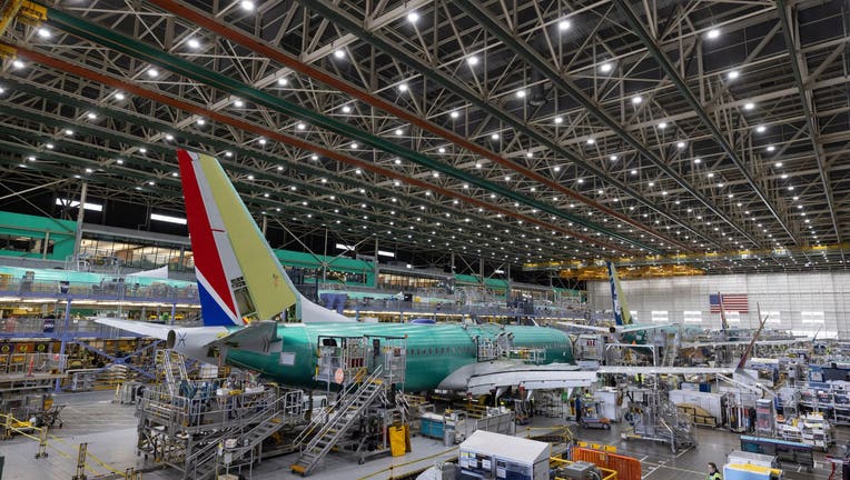 FILE - Boeing employees work on a 737 MAX airplane on the final assembly line at Boeing's plant in Renton, Wash., on June 15, 2022. (Ellen M. Banner/The Seattle Times via AP, Pool, File)