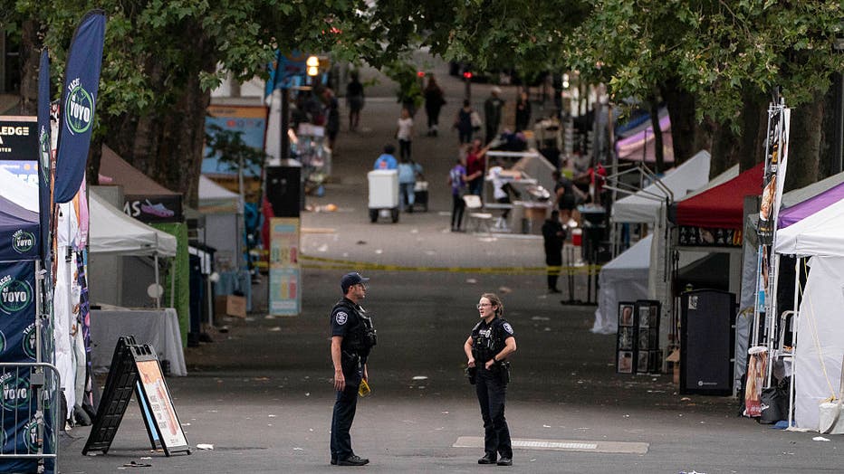 JULY 26: Police officers keep watch after a mass shooting at the Bite of Seattle food festival on July 26, 2026 in Seattle, Washington.