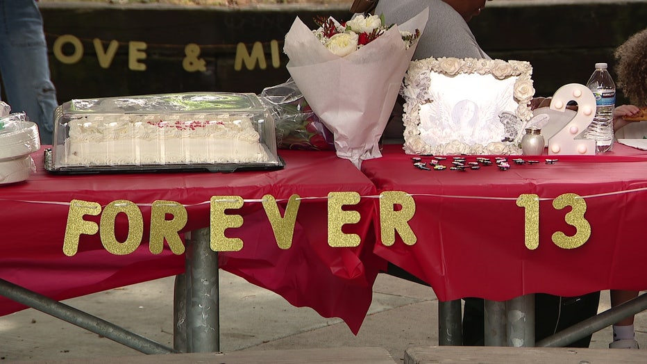 A banner reads "Forever 13" at a memorial event for 13-year-old Jayda Johnson two years after she was shot and killed at Alderwood Mall in Lynnwood