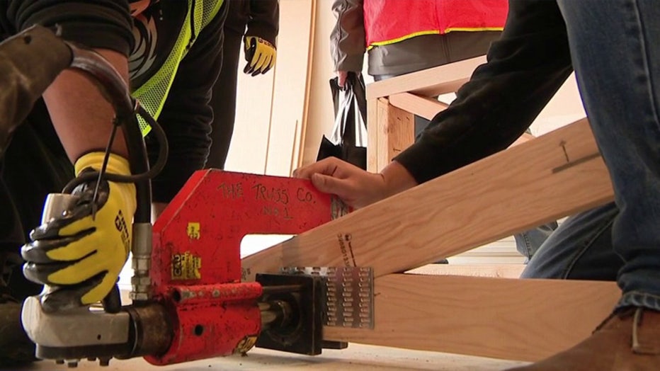 Washington construction leaders are pushing to attract young workers as the industry faces a massive labor shortage with 40 percent of its workforce nearing retirement by 2031. While artificial intelligence streamlines behind-the-scenes tasks like permitting, industry experts emphasize that physical trades require a human element that technology cannot replace. Regional programs and hands-on job site training are working to bridge the workforce gap by introducing high school students to careers in welding, framing, and plumbing.
