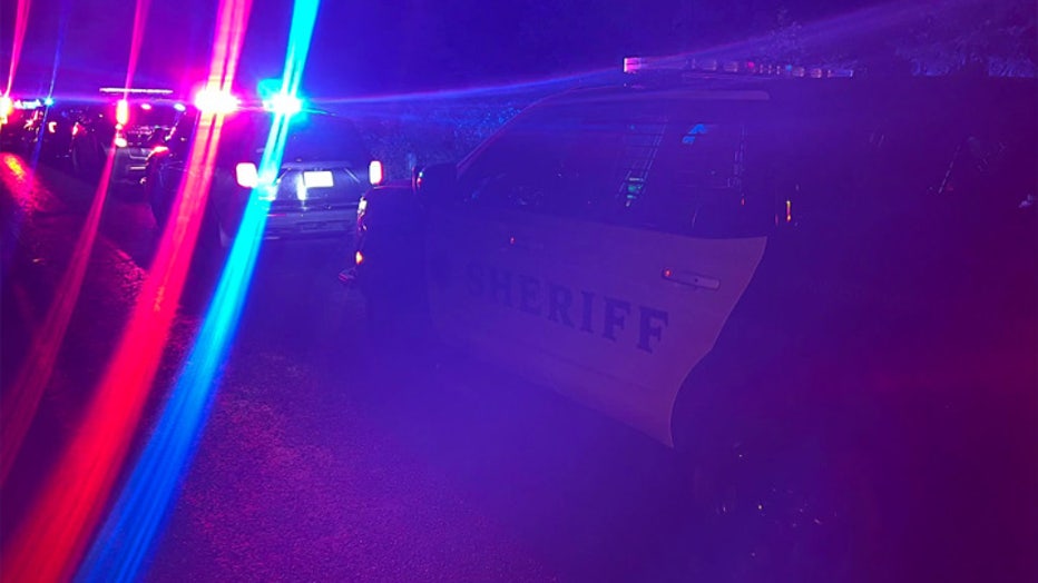 Police lights and cars at the scene of an officer involved shooting in Rainier, WA
