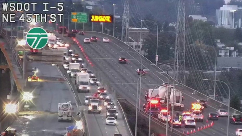 A two-semi-truck crash blocked multiple southbound lanes of I-5 on the Ship Canal Bridge early Wednesday, causing 5-mile backups. WSDOT warns of an extended closure with no estimated reopening time as emergency crews respond to the scene. Drivers are urged to seek alternative routes while further details on the collision and driver conditions remain unavailable.
