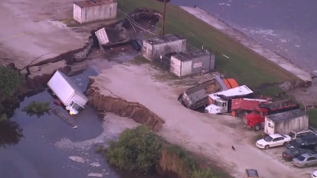 Possible sinkhole opens up, swallows trucks near Orlando International Airport
