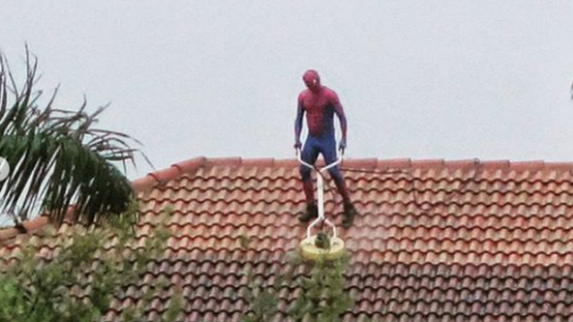 'Spider-Man' seen pressure washing roof of Florida home during rainstorm