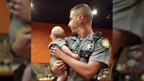 Police officer at Kentucky restaurant holds 'fussy' baby so mom can eat, viral photo shows