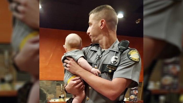 36bfff3c-officer holds baby_1570186402275.png-402429.jpg