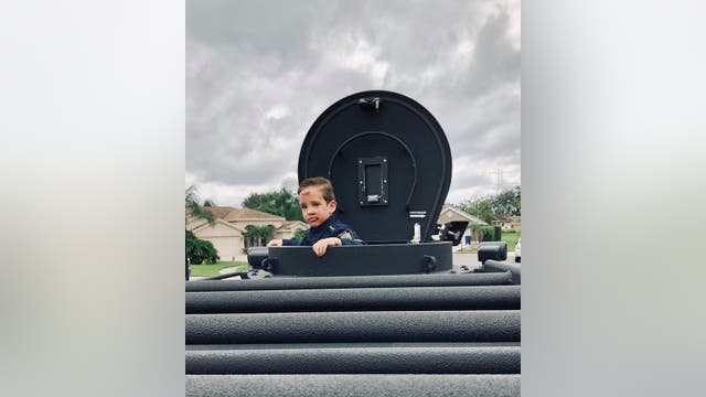 SWAT officers surprise boy hit by truck on Halloween