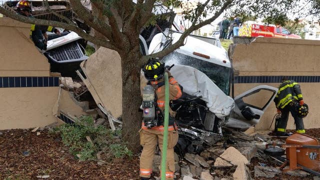Delivery crew rushes to help man stuck in burning truck