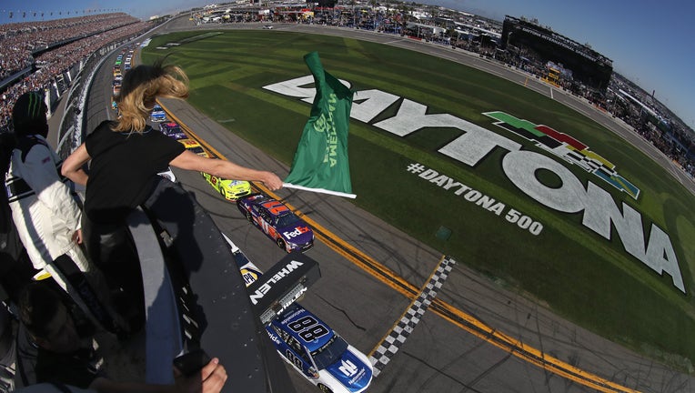 DAYTONA BEACH, FL - FEBRUARY 18: Actress Charlize Theron waves the green flag to start the Monster Energy NASCAR Cup Series 60th Annual Daytona 500 at Daytona International Speedway on February 18, 2018 in Daytona Beach, Florida. (Photo by Sean Gardner/Getty Images)