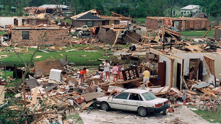 A group of people sift 28 August 1992 through the