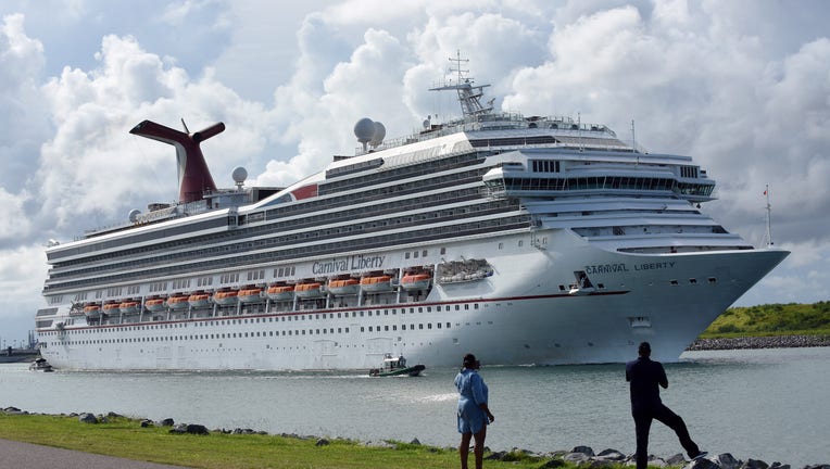 People watch as the Carnival Liberty cruise ship departs