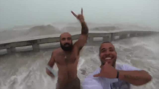 Large waves soak men in Key West as Elsa regains hurricane status