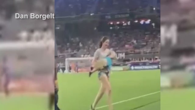 Mother tackles toddler who runs onto pitch during Orlando City soccer game