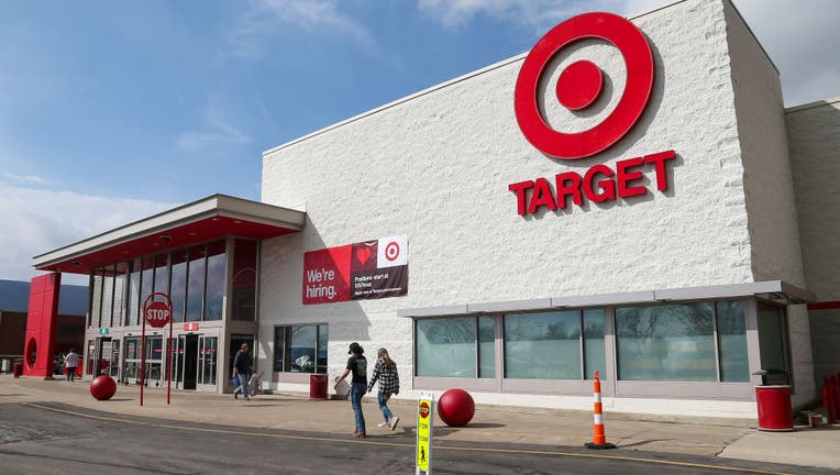 Shoppers walk in front of a Target store at the Lycoming