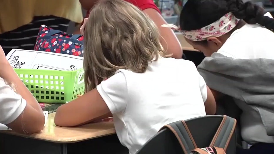 8319e90a-child in classroom