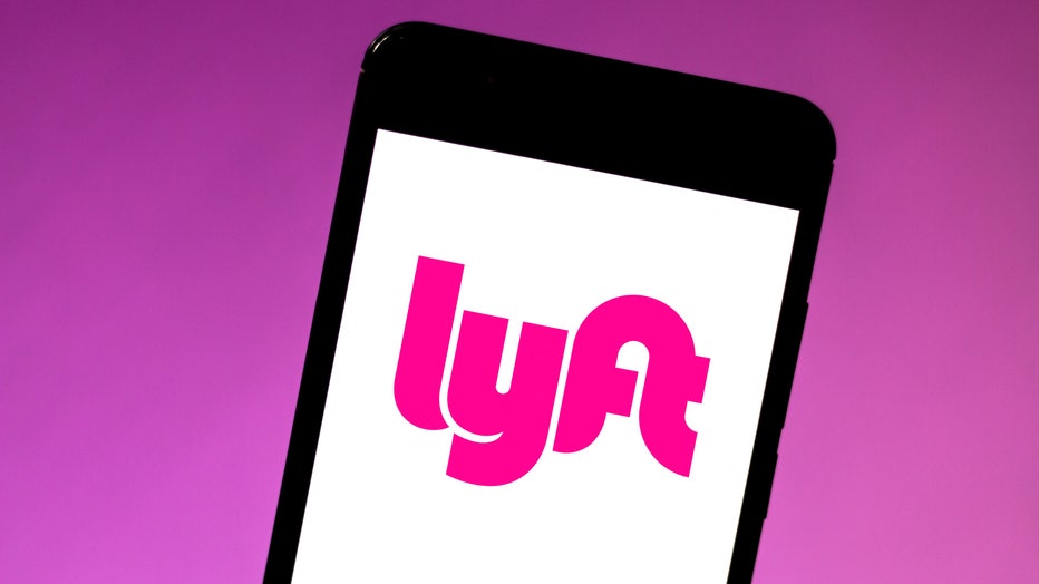 fcc347eb-In this photo illustration the Lyft logo is seen displayed