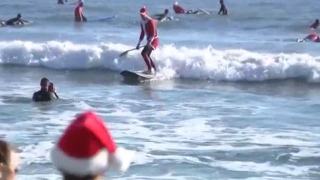 'Surfing Santas' hit the waves at Cocoa Beach amid Florida freeze
