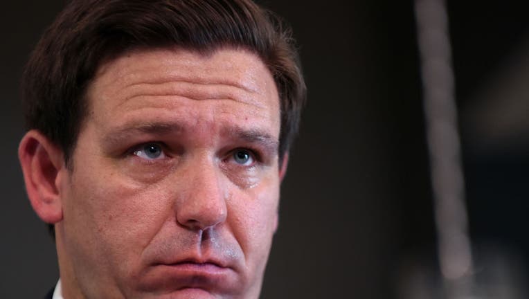 Florida Governor Ron DeSantis listens to a question from the