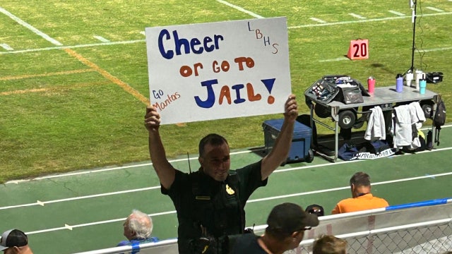 Florida deputy goes viral for hilarious 'cheer or go to jail' sign at high school football game